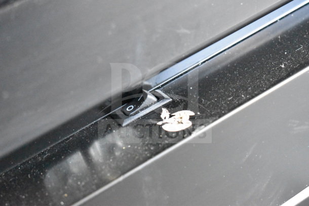 Close-up of a black on/off switch on a 2021 Diamond Cargo 8.5'x24' cold food/beverage trailer, VIN 53NBE2424M1089867.