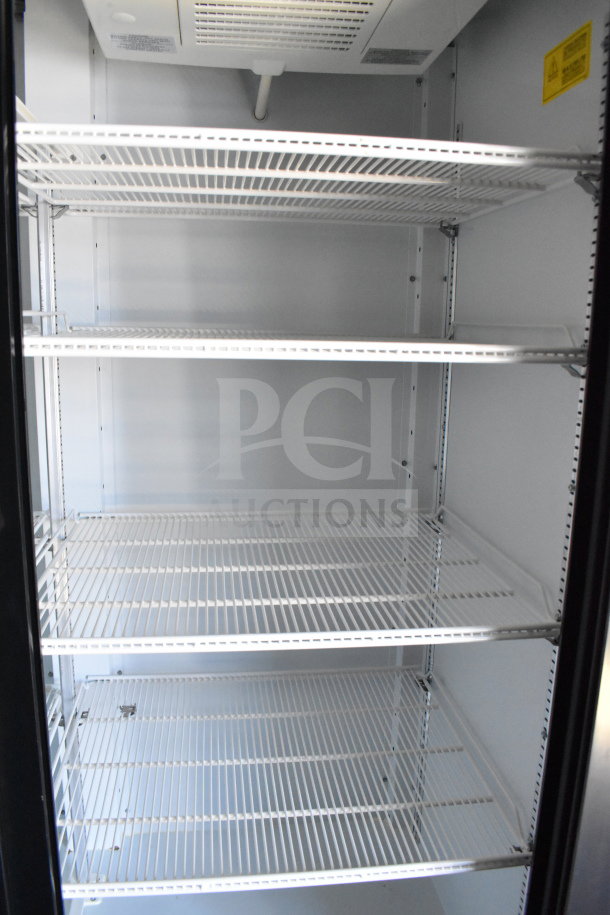 Interior view of 2021 Diamond Cargo 8.5'x24' Cold Food/Beverage Trailer, featuring four metal wire shelves for storage.