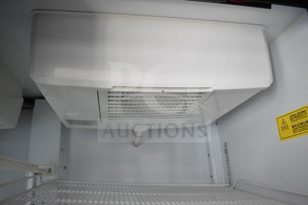 Interior view of a 2021 Diamond Cargo cold food/beverage trailer, showing shelving and cooling unit. Clean condition.