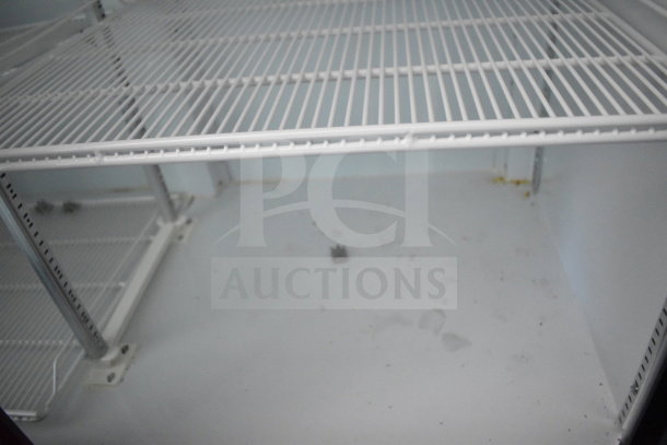 2021 Diamond Cargo food trailer interior, showcasing white metal shelving and floor in clean condition.
