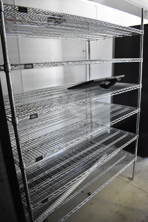 2021 Diamond Cargo 8.5'x24' trailer interior with metal shelving. Ideal for cold food/beverage storage, excellent condition.