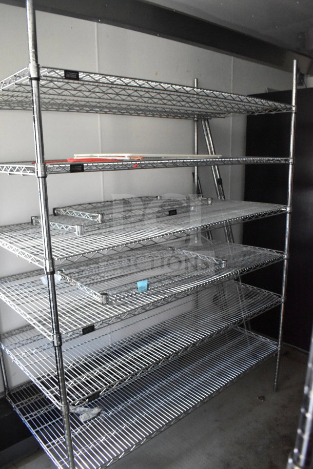 2021 Diamond Cargo 8.5'x24' trailer interior with metal shelving. VIN: 53NBE2424M1089867. Clean condition.