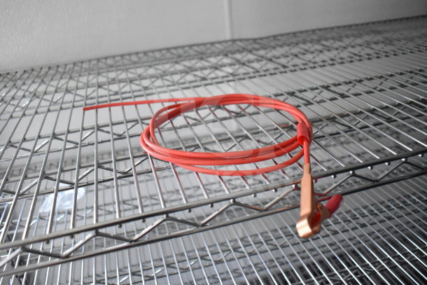 2021 Diamond Cargo 8.5'x24' trailer shelving with a coiled red cable.