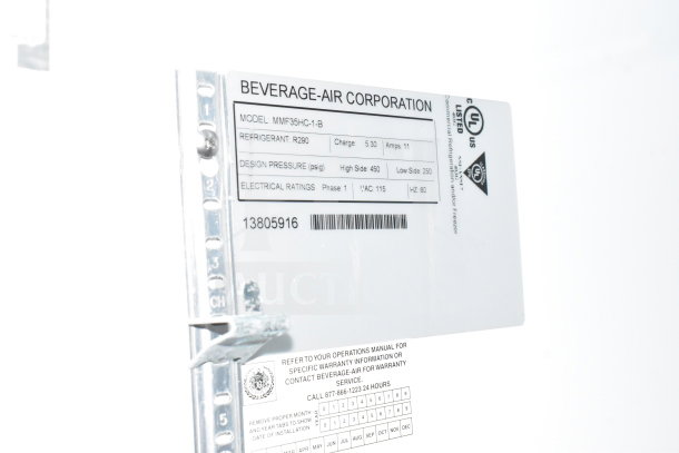 Alt text: "Beverage-Air Corporation label on cold food trailer shows model MMF35HC-1-B, refrigerant R290, electrical and pressure specs."