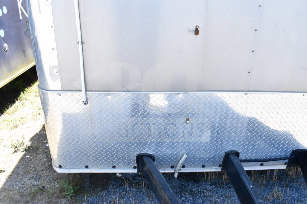 2021 Diamond Cargo 8.5'x24' cold food trailer front view, showing diamond plate panel, slight dent, and rust mark.