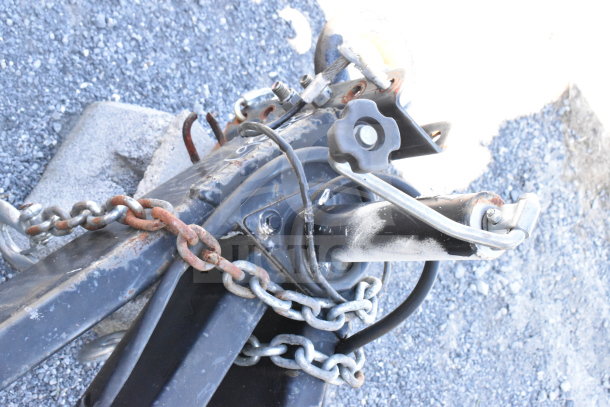 Trailer hitch close-up of the 2021 Diamond Cargo 8.5'x24' cold food/beverage trailer, showing chains and locking mechanism.