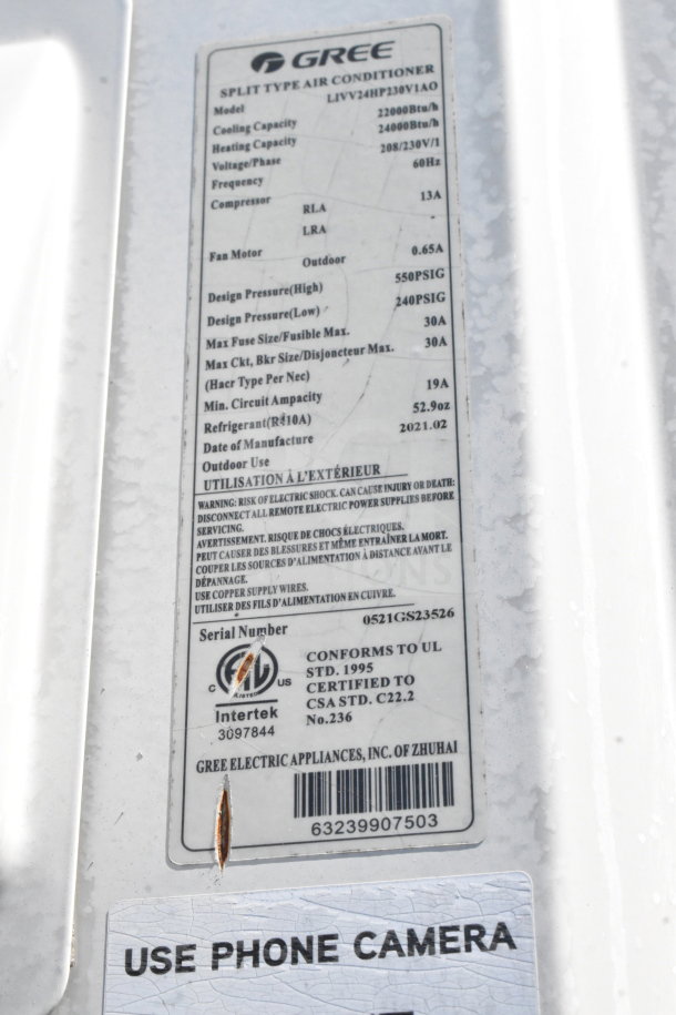 2021 Diamond Cargo 8.5'x24' trailer with Gree air conditioner label showing specifications and certification details.