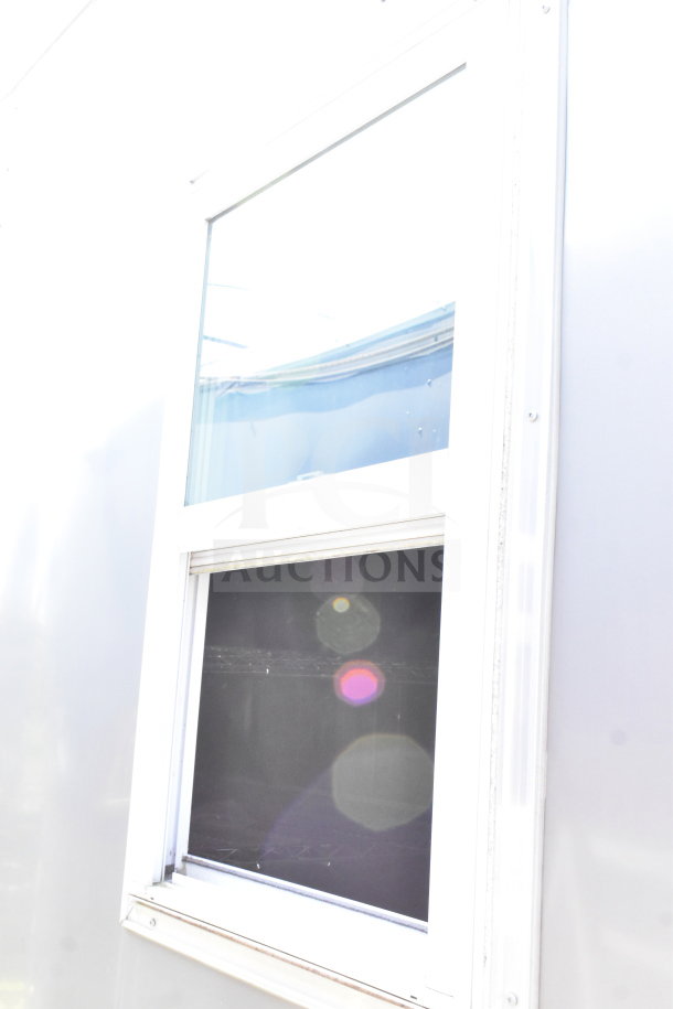 2021 Diamond Cargo 8.5'x24' cold food/beverage trailer window detail, well-maintained condition.