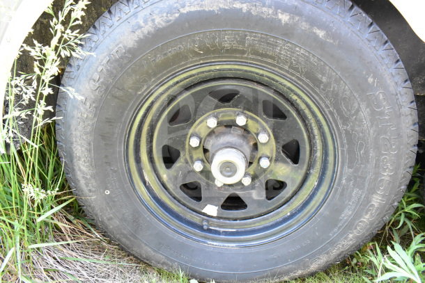 Black tire and rim of 2021 Diamond Cargo 8.5'x24' Cold Food/Beverage Trailer, showing tread pattern and lug nuts.