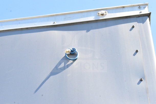 2021 Diamond Cargo 8.5'x24' cold food/beverage trailer. Side view showing metal exterior with a blue cable ring attachment.