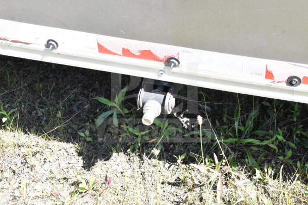 2021 Diamond Cargo 8.5'x24' trailer underside showing drainage outlet and exterior detailing.
