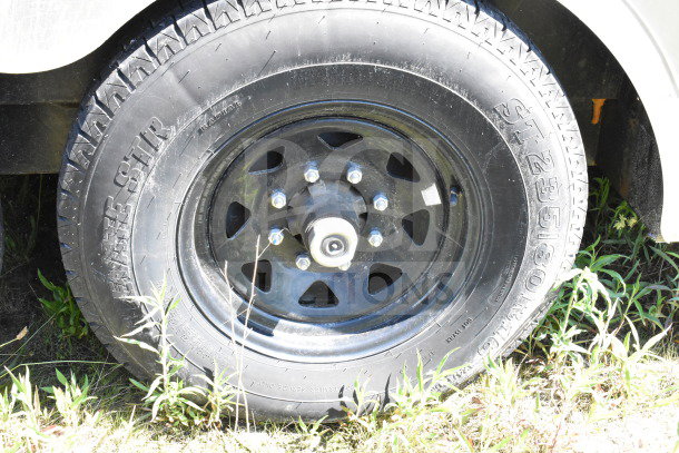 Wheel of a 2021 Diamond Cargo 8.5'x24' trailer, featuring ST235/80R16 tire in fair condition, suitable for cold food transport.