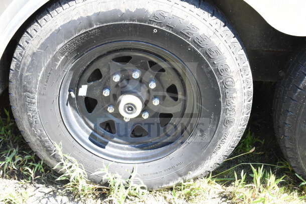 Close-up of a tire on a 2021 Diamond Cargo 8.5'x24' cold food/beverage trailer. Visible tire details include "ST235/80R16".