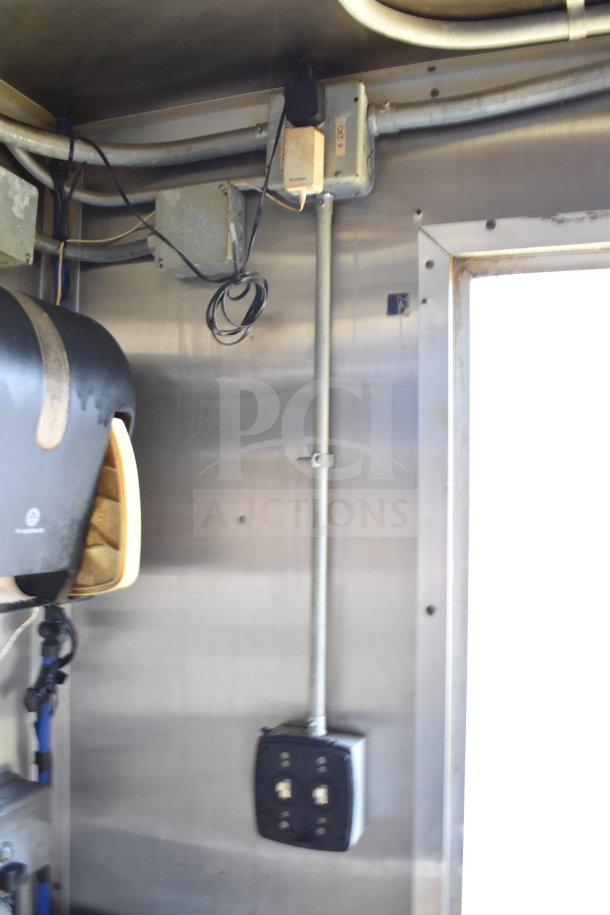 Interior of 2019 Diamond Cargo 8.5'x24' food trailer showing electrical wiring and appliances, used condition.