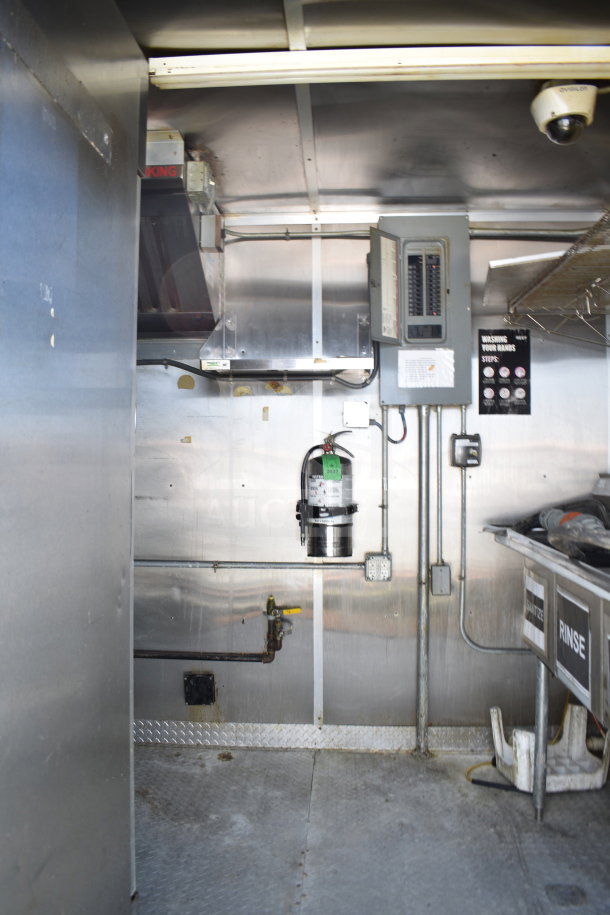 2019 Diamond Cargo 8.5'x24' food trailer interior, showing grease hood, suppression system, and refrigeration setup.