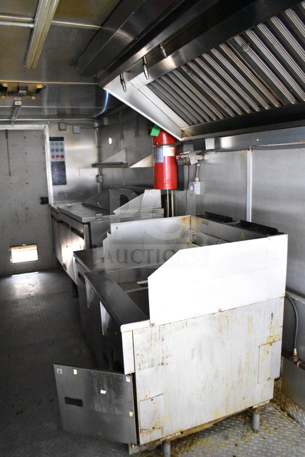 2019 Diamond Cargo 8.5'x24' food trailer interior with grease hood, suppression system, fryer, and refrigeration. Good condition.