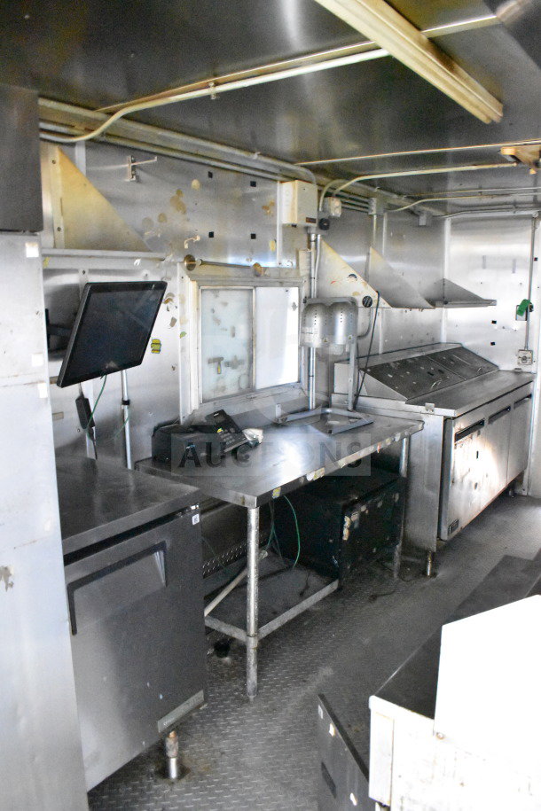 2019 Diamond Cargo 8.5'x24' food trailer interior with grease hood, suppression system, refrigeration, and fryer. Good condition.