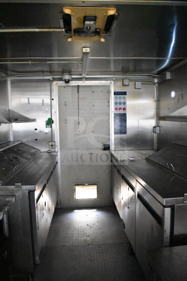 2019 Diamond Cargo 8.5'x24' food trailer interior with stainless steel counters, grease hood, suppression system, and refrigeration units.
