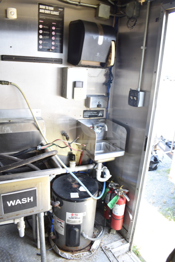 2019 Diamond Cargo 8.5'x24' food trailer interior with wash sink, hot water heater, and fire extinguishers.