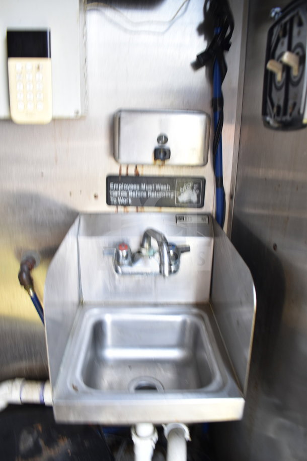 2019 Diamond Cargo food trailer interior with stainless steel sink and handwashing instructions.