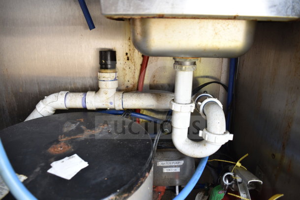 Interior view of 2019 Diamond Cargo 8.5'x24' food trailer showing plumbing, pipes, and water pump labeled "CKT-18." Signs of wear present.
