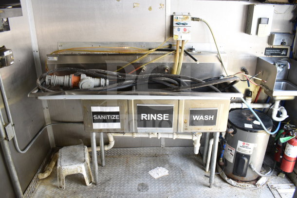 2019 Diamond Cargo 8.5'x24' food trailer interior with three-section sink for sanitize, rinse, wash; visible wiring and equipment.
