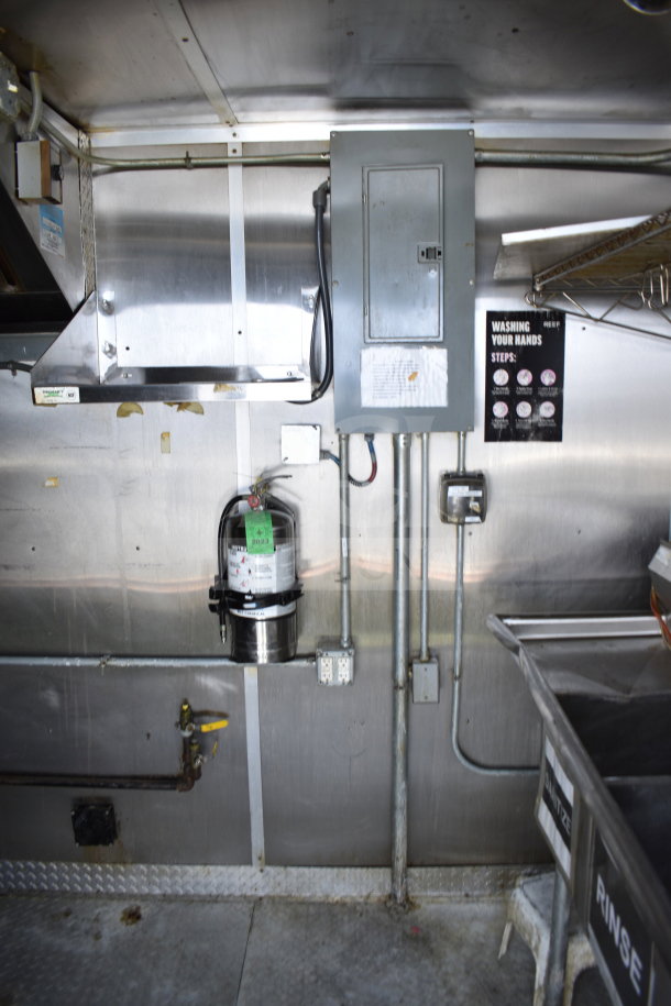 2019 Diamond Cargo 8.5'x24' food trailer interior with grease hood, suppression system, and stainless steel fittings.