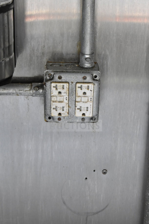 Close-up of electrical outlets in a stainless-steel interior of a 2019 Diamond Cargo 8.5'x24' food trailer.