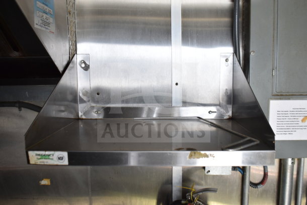 Steel interior of 2019 Diamond Cargo food trailer showcasing grease hood system and stainless steel shelf. NSF certification visible.