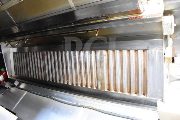 2019 Diamond Cargo 8.5'x24' food trailer interior with grease hood, suppression system, and "No Smoking" sign.