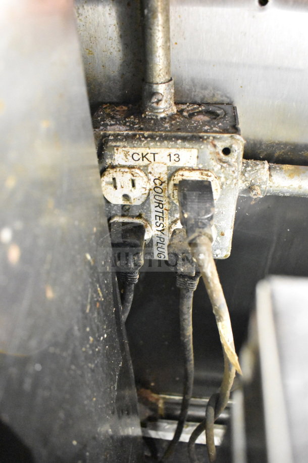 Close-up of electrical outlet labeled "CKT 13" and "COURTESY PLUG" in a 2019 Diamond Cargo food trailer, showing wear.