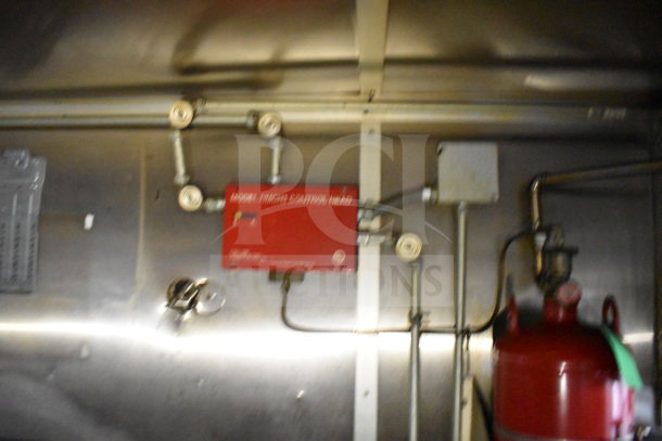 2019 Diamond Cargo 8.5'x24' food trailer interior with grease hood, suppression system pipes, and red control box.