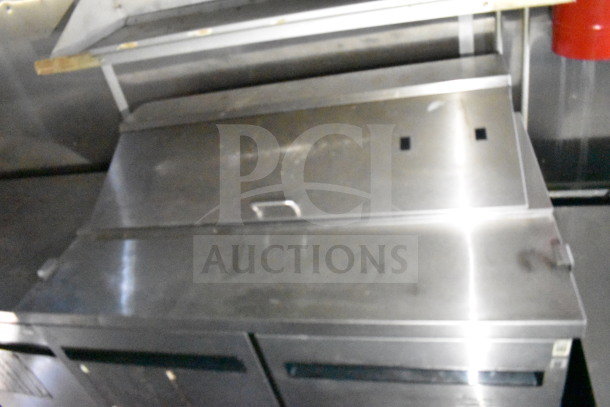 2019 Diamond Cargo food trailer interior with stainless steel refrigeration unit, featuring grease hood and fryer system.