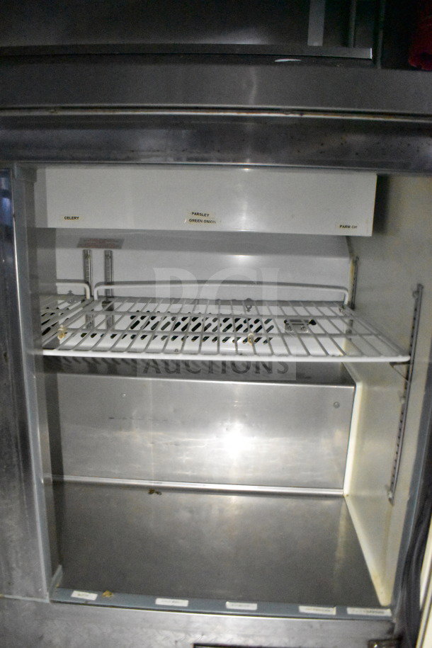 Interior view of 2019 Diamond Cargo food trailer showing refrigeration unit with wire rack shelves labeled for produce.