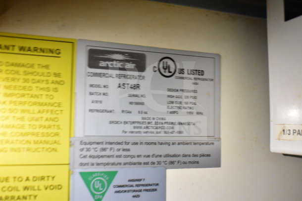 Label on Arctic Air commercial refrigerator model AST48R, includes design pressure, refrigeration details, and manufacturer info.
