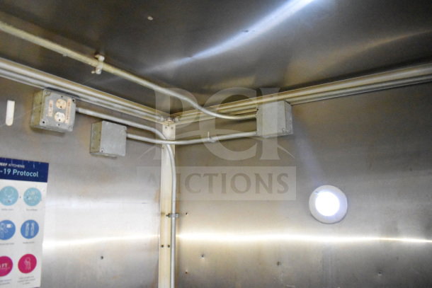 Interior wiring and outlets of a 2019 Diamond Cargo 8.5'x24' food trailer, featuring metal wall panels.