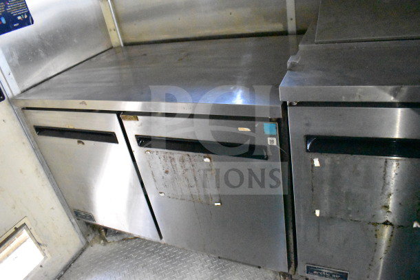 2019 Diamond Cargo 8.5'x24' food trailer interior; features stainless steel refrigeration units, grease hood, and suppression system.