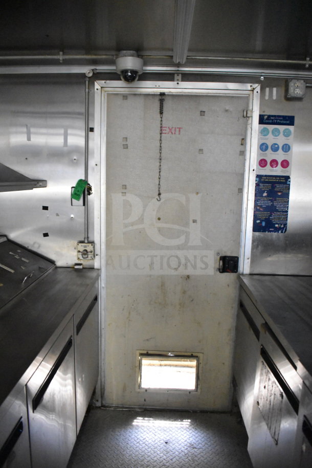 2019 Diamond Cargo 8.5'x24' food trailer interior with grease hood, surveillance camera, and COVID-19 protocol signage.