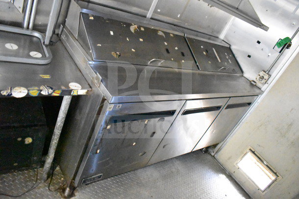 2019 Diamond Cargo 8.5'x24' food trailer features stainless steel counters, refrigeration units, and grease hood. Visible wear.