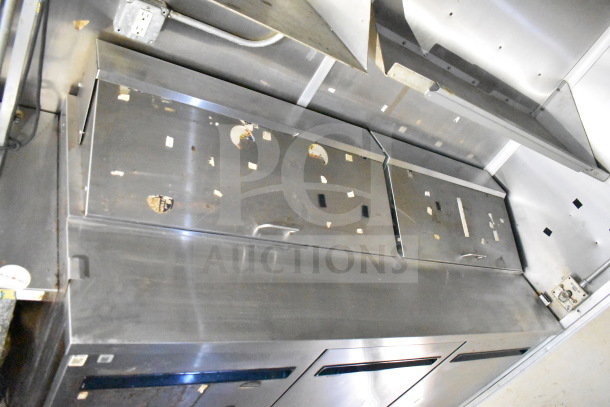2019 Diamond Cargo 8.5'x24' food trailer interior showing stainless steel surfaces and storage, grease hood visible.