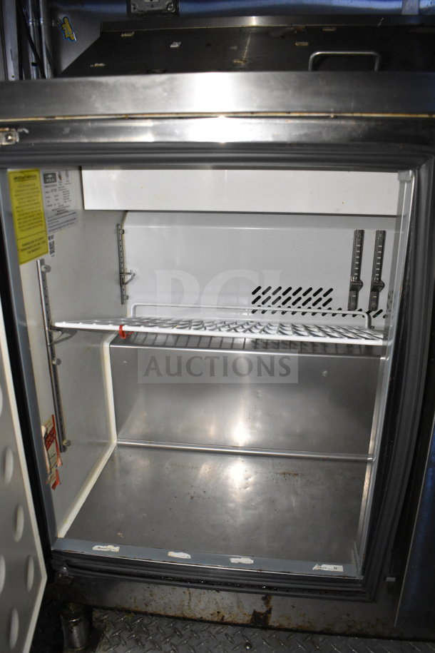 Interior view of a Diamond Cargo trailer's refrigeration unit, featuring metal shelving and a temperature gauge. Clean condition.