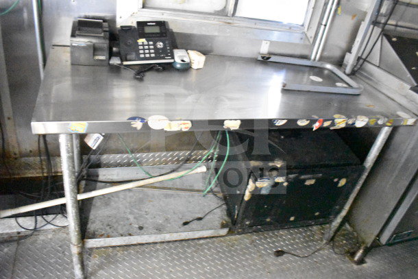 Interior view of a 2019 Diamond Cargo 8.5'x24' Food Trailer featuring a stainless steel prep table with attached phone and cables. Signs of wear visible.