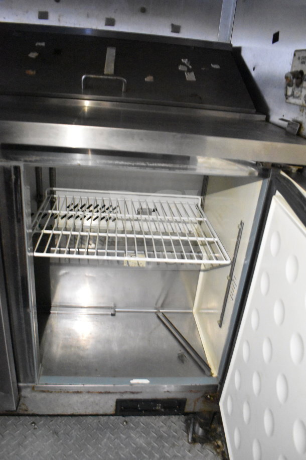 2019 Diamond Cargo 8.5'x24' food trailer interior showing stainless steel surface with open refrigeration unit.