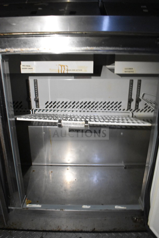 2019 Diamond Cargo food trailer interior showing shelving and labels for food storage. Visible wear and grease stains.