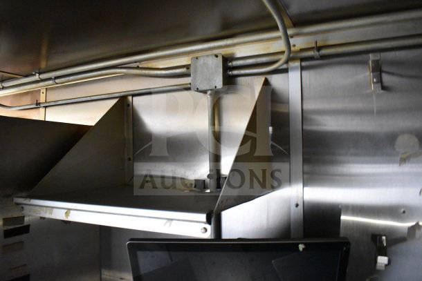 Interior view of 2019 Diamond Cargo 8.5'x24' food trailer showing grease hood and industrial wiring. Excellent condition.