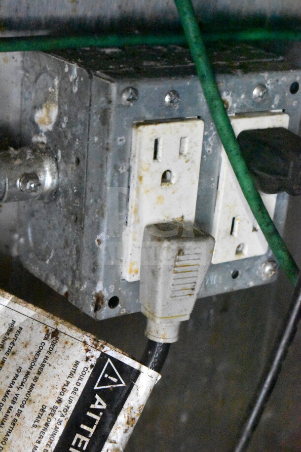 Close-up of an electrical outlet in a 2019 Diamond Cargo 8.5'x24' food trailer. Outlet shows signs of use. 
