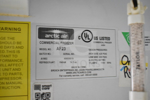 Label inside an Arctic Air commercial freezer model AF23, showing specifications like refrigerant type, design pressures, and electric rating.