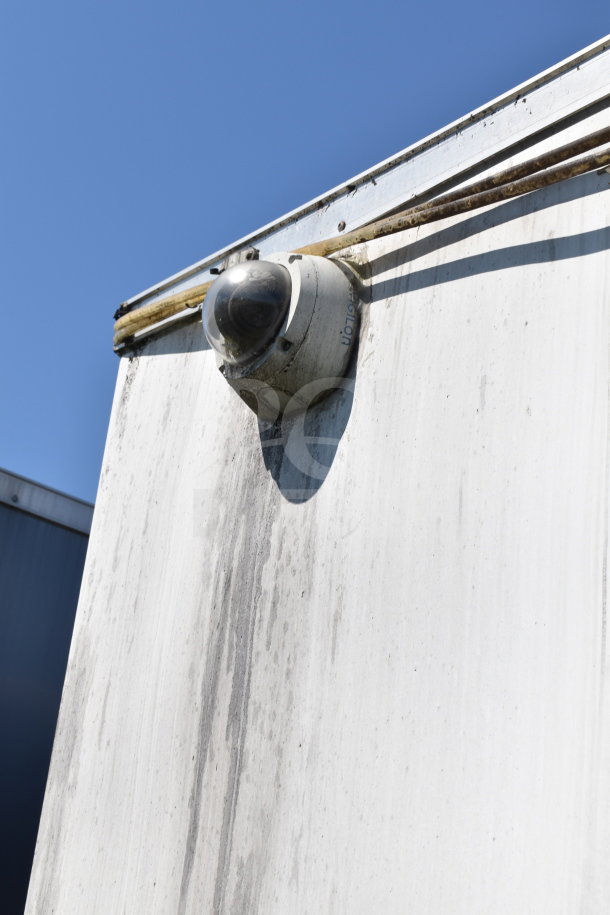 2019 Diamond Cargo food trailer corner with dome camera, visible wiring, and weathered surface.