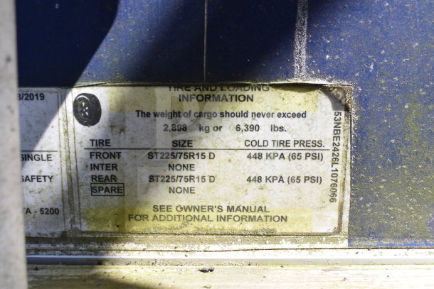 Close-up image of tire and loading information label on 2019 Diamond Cargo food trailer, VIN 53NBE2426L1076066.