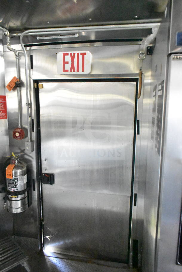 2020 LGS TX food trailer interior with exit door, CaptiveAire grease hood, suppression system, and fire extinguisher.